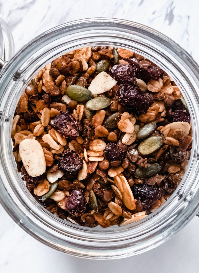 maple cinnamon lentil granola in a glass jar on a marble surface