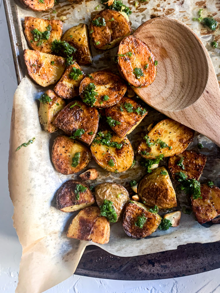 crispy roasted potato on a wooden spoon