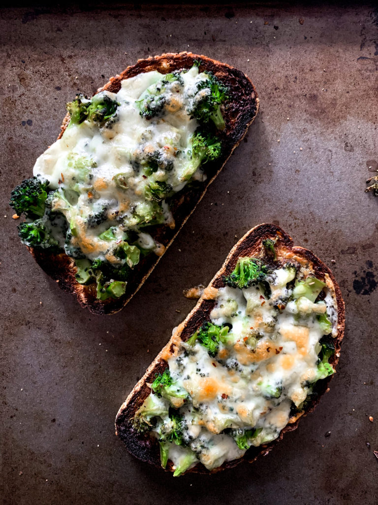 two broccoli melts on a sheet pan