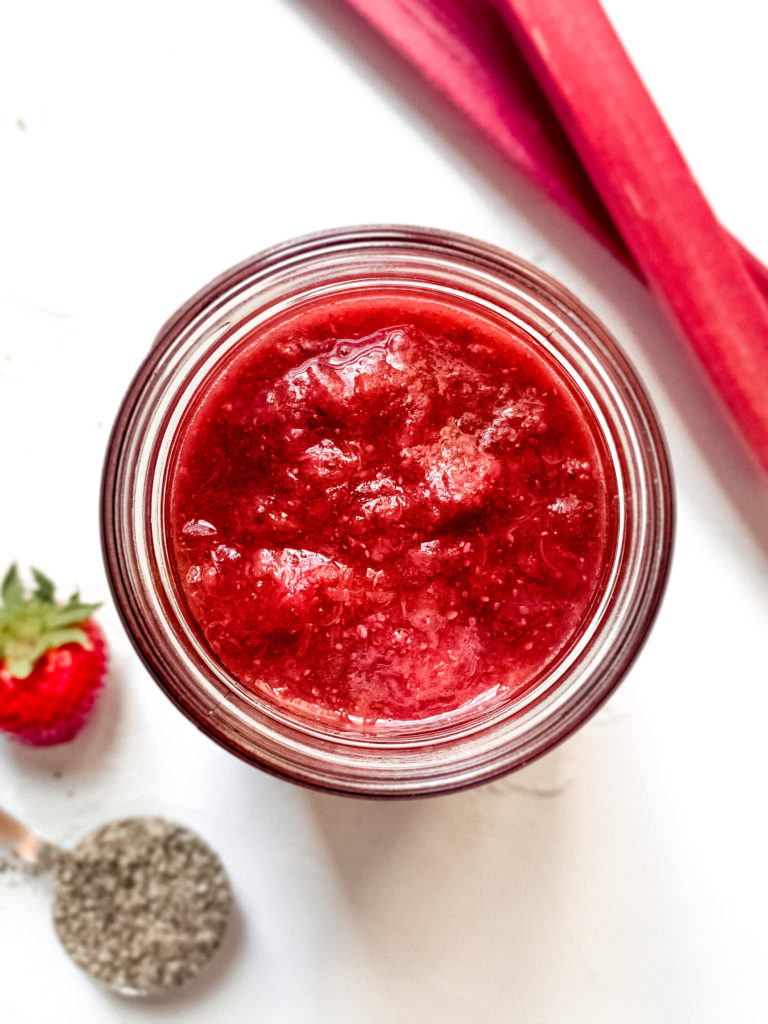 Overhead shot of strawberry rhubarb chia jam in a jar