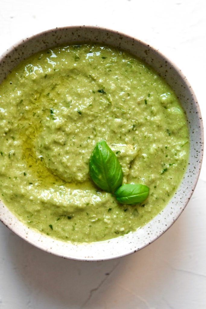 overhead shot of garlic scape and basil pesto in a bowl