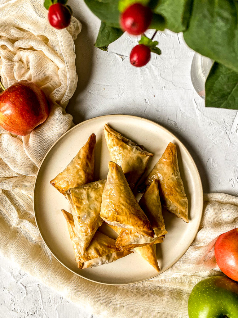 apple cinnamon turnovers piled on a plate