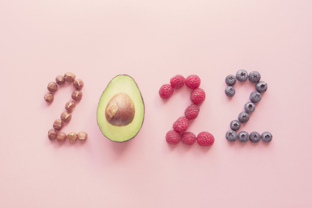 2022 made from healthy food on pink background; top nutrition trends of 2022