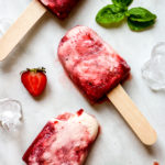 strawberry basil swirl yogurt popsicles laying in a verticle line